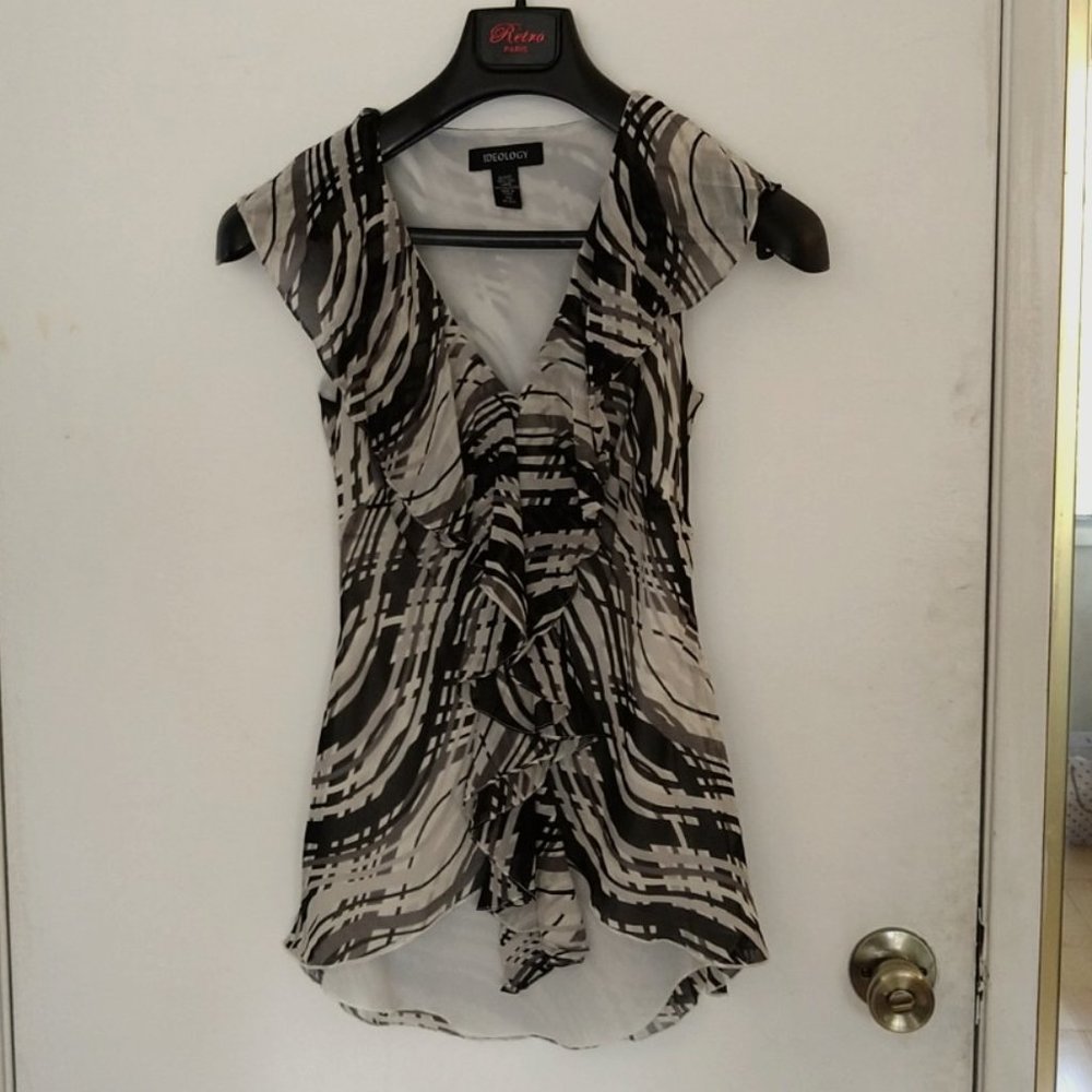 Silk sleeveless blouse with ruffles in front